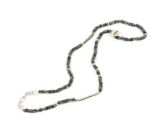 Necklace with brown green beads and silver chain on a white background